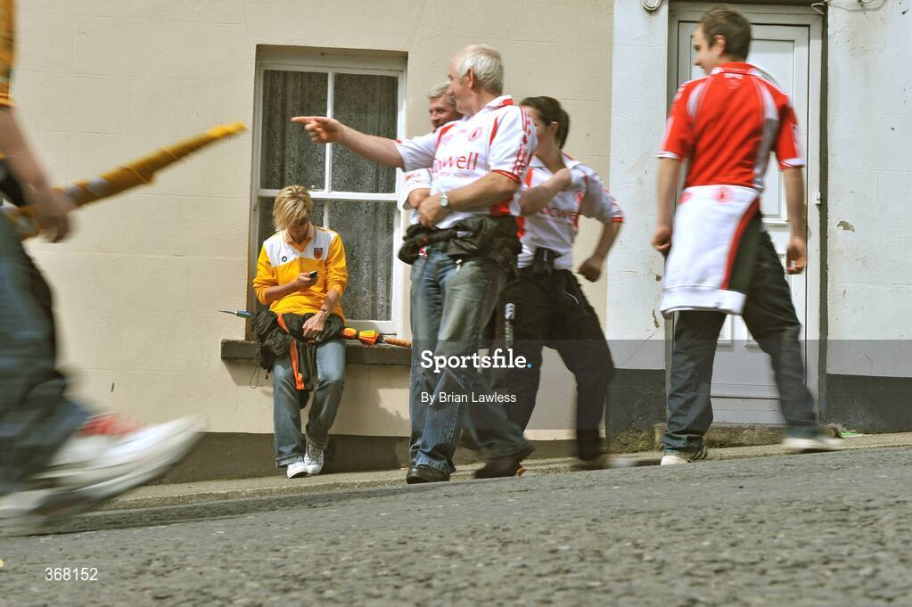 19 July 2009; Antrim fan Bridget Hamill checks her phone as Tyrone fans make their way to the match. GAA Football Ulster Senior Championship Final, Tyrone v Antrim, St Tighearnach's Park, Clones, Co. Monaghan. Picture credit: Brian Lawless / SPORTSFILE
