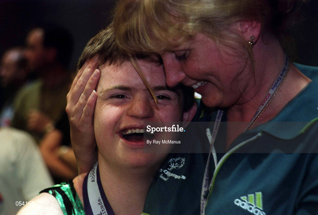 2 July 1999; Adam Morrison from Newtownards, Down who won six medals, one Gold, two Silver and three Bronze is congratulated by Gymnastics Head Coach Sinéad Byrne after the presentation of medals at the 1999 Special Olympics World Summer Games in Raleigh, North Carolina, USA. Photo by Ray McManus/Sportsfile