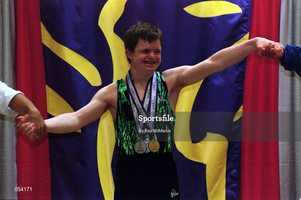2 July 1999; Gymnaist Adam Morrison from Newtownards, Down who won six medals, one Gold, two Silver and three Bronze holds hands with the bronze and silver medalists at the presentation during the 1999 Special Olympics World Summer Games in Raleigh, North Carolina, USA. Photo by Ray McManus/Sportsfile
