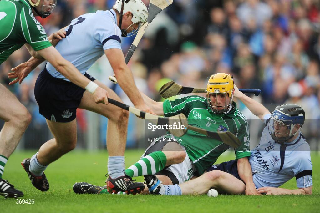26 July 2009; David Breen, Limerick, attempts to kick the sliothar goal wards under pressure from Dublin players Tomas Brady, left, and Maurice O'Brien. GAA All-Ireland Senior Hurling Championship Quarter-Final, Dublin v Limerick, Semple Stadium, Thurles, Co. Tipperary. Picture credit: Ray McManus / SPORTSFILE