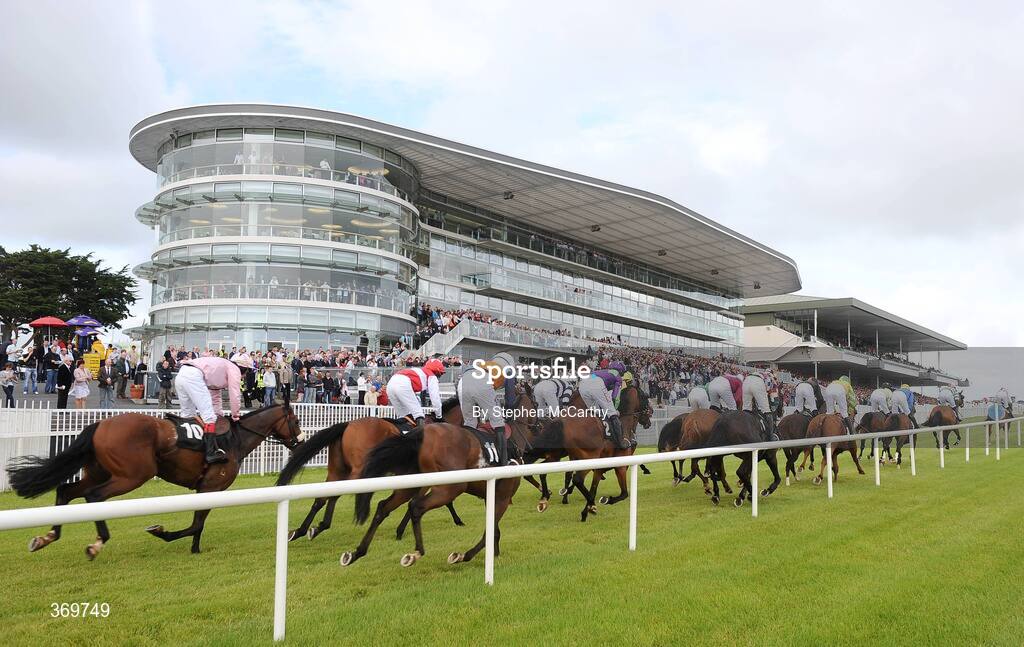 27 July 2009; The runners and riders pass grandstand during the Ghotel.ie & Hotelmeyrick.ie Novice Hurdle. Galway Racing Festival, Ballybrit, Galway. Picture credit: Stephen McCarthy / SPORTSFILE