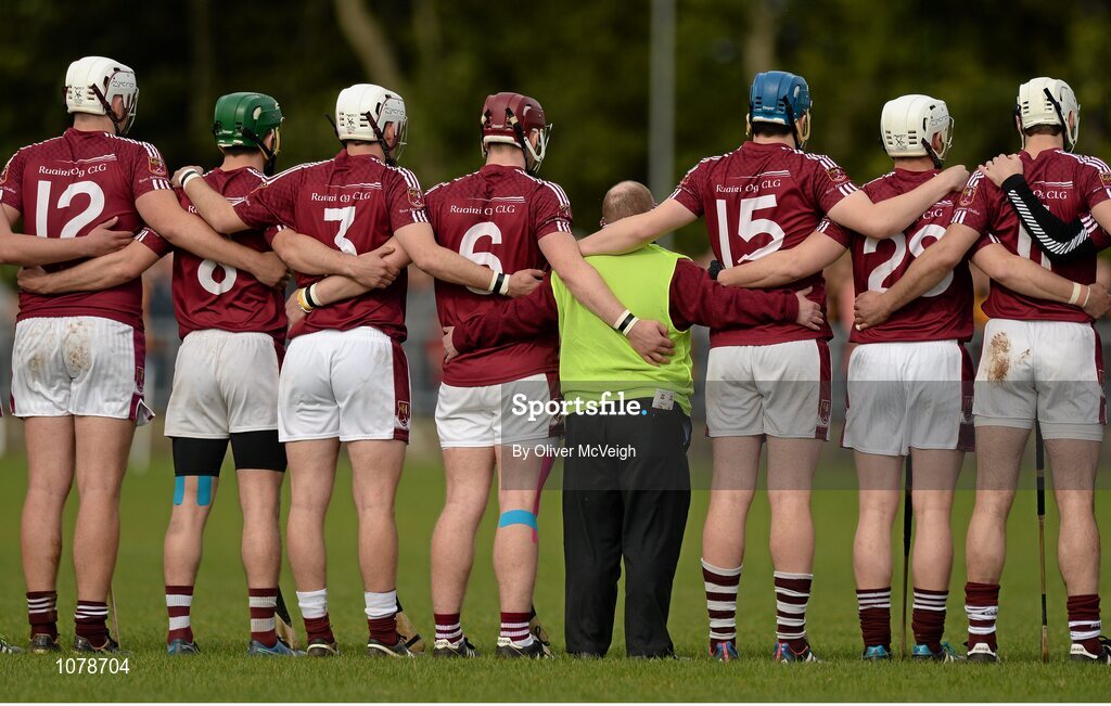 27 September 2015; Ruairi Og Cushendall team mascot John McKillop, centre, standing arm in arm with the players during the National Anthem. Antrim Senior Championship Hurling Final, Ruairi Og Cushendall v Ballycastle McQuillan, Dunloy GAA Club, Dunloy, Co. Antrim. Picture credit: Oliver McVeigh / SPORTSFILE