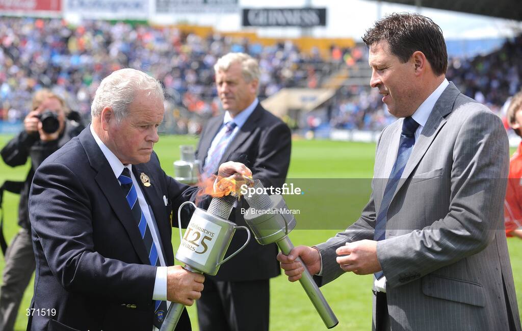 12 July 2009; Pat Flynn, right, Chairman of the Waterford County Board, has his torch lit by Jimmy O'Gorman, Chairman of the Munster Council, during the pre-match celebrations. GAA Hurling Munster Senior Championship Final, Tipperary v Waterford, Semple Stadium, Thurles, Co. Tipperary. Picture credit: Brendan Moran / SPORTSFILE