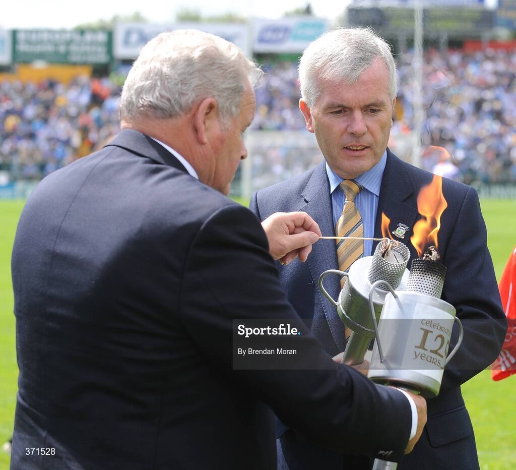 12 July 2009; Barry O'Brien, right, Chairman of the Tipperary County Board, has his torch lit by Jimmy O'Gorman, Chairman of the Munster Council, during the pre-match celebrations. GAA Hurling Munster Senior Championship Final, Tipperary v Waterford, Semple Stadium, Thurles, Co. Tipperary. Picture credit: Brendan Moran / SPORTSFILE