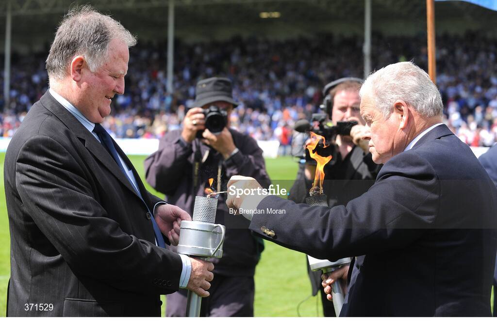 12 July 2009; Jerome Conway, left, Chairman of the Kerry County Board, has his torch lit by Jimmy O'Gorman, Chairman of the Munster Council, during the pre-match celebrations. GAA Hurling Munster Senior Championship Final, Tipperary v Waterford, Semple Stadium, Thurles, Co. Tipperary. Picture credit: Brendan Moran / SPORTSFILE
