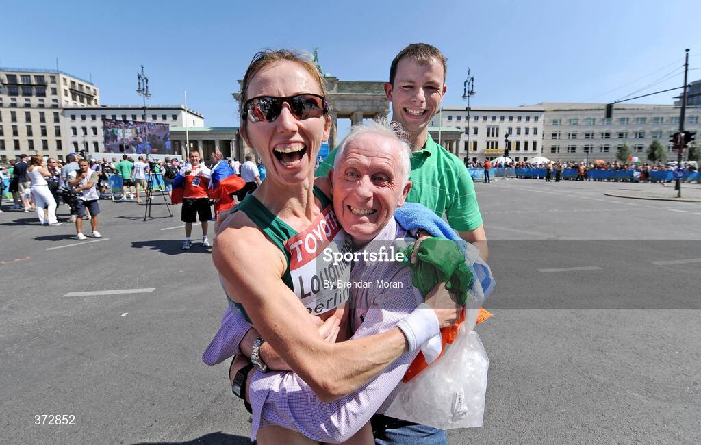 16 August 2009; Ireland's Olive Loughnane is congratulated by her father Matt and brother Brendan after finishing second and winning a silver medal in the Women's 20K Walk Final. 12th IAAF World Championships in Athletics, Berlin, Germany. Picture credit: Brendan Moran  / SPORTSFILE