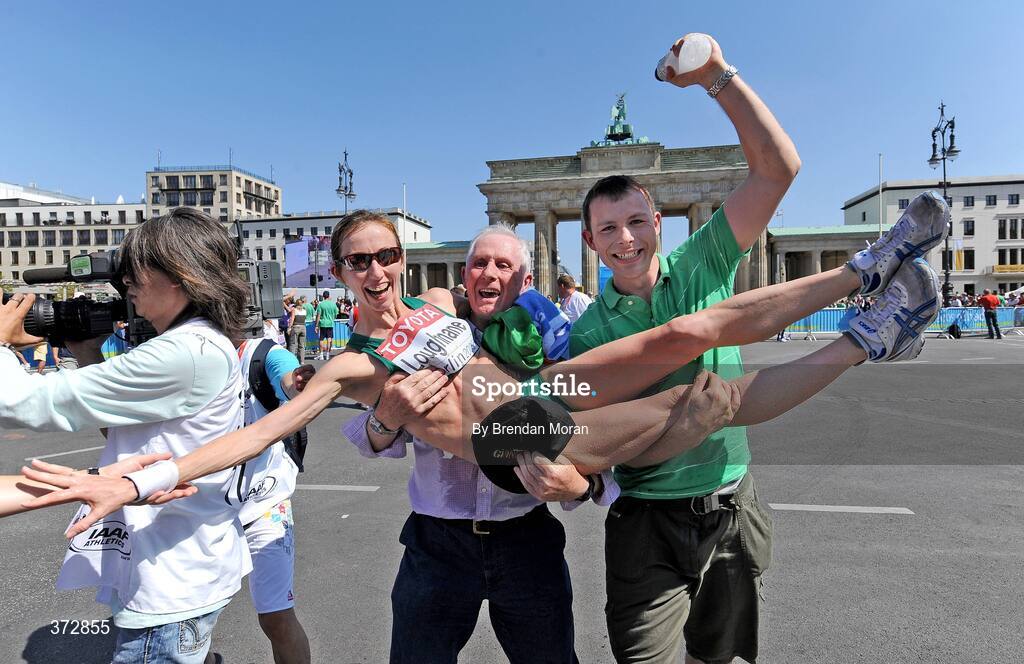 16 August 2009; Ireland's Olive Loughnane is congratulated by her father Matt and brother Brendan after finishing second and winning a silver medal in the Women's 20K Walk Final. 12th IAAF World Championships in Athletics, Berlin, Germany. Picture credit: Brendan Moran  / SPORTSFILE