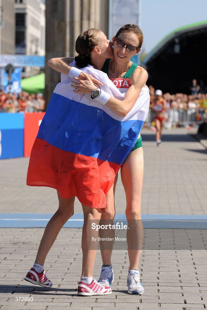 16 August 2009; Ireland's Olive Loughnane celebrates with winner Olga Kaniskina of Russia after crossing the finish line to finish second in a season best time of 1:28.58 and win a silver medal in the Women's 20K Walk Final.12th IAAF World Championships in Athletics, Berlin, Germany. Picture credit: Brendan Moran  / SPORTSFILE
