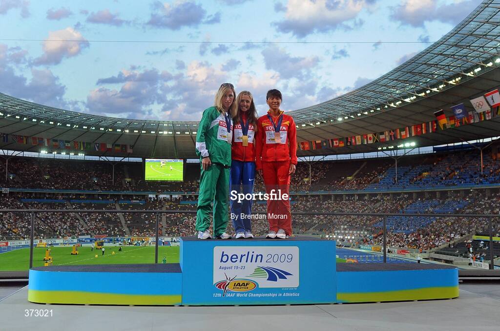 16 August 2009; Ireland's Olive Loughnane, with her Silver medal, stands alongside winner Olga Kaniskina, centre, of Russia, and third placed Hong Liu, of China, on the medal podium in the Olympic Stadium after the medal ceremony for the Women's 20K Walk Final. 12th IAAF World Championships in Athletics, Berlin, Germany. Picture credit: Brendan Moran  / SPORTSFILE