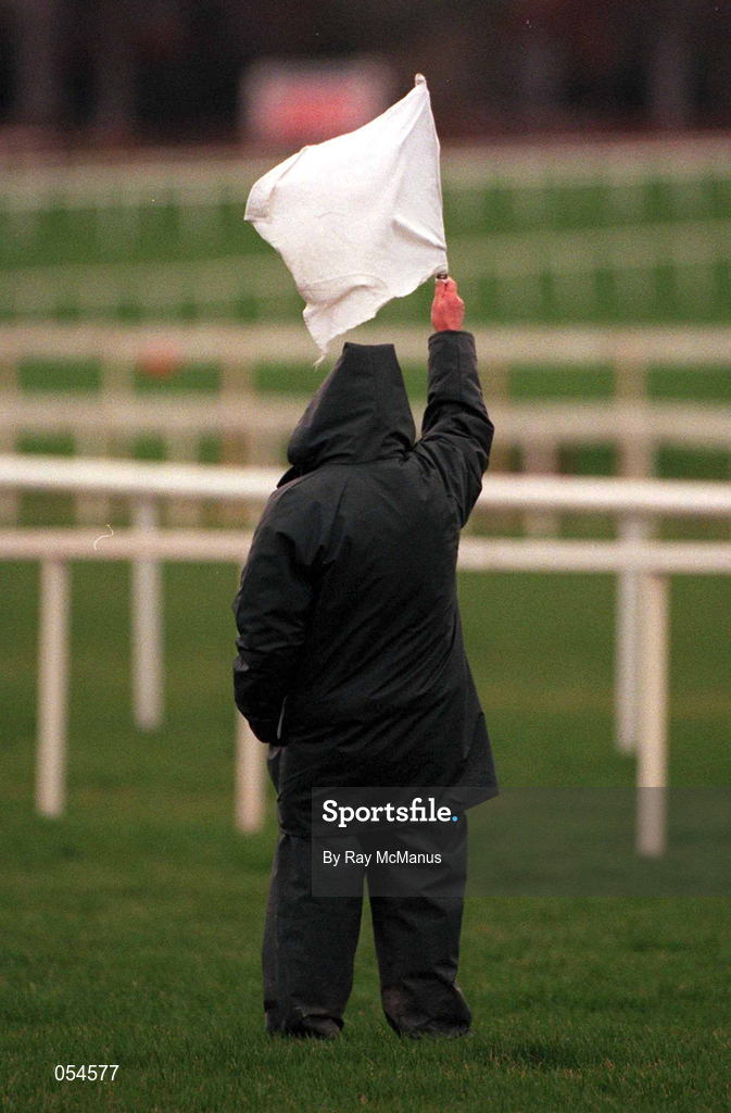 26 December 2000; A racecourse official raises the white flag during day one of the Christmas Festival at Leopardstown Racecourse in Dublin. Photo by Ray McManus/Sportsfile
