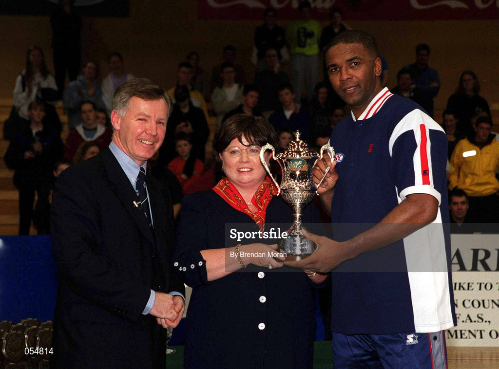 30 January 2000; Denny Notre Dame captain/coach, Anthony Jenkins, receives the cup from An Tanaiste Mary Harney TD and Finn Ahern, left, President of the Irish Basketball Association, following the Senior Men's Sprite Cup Final between Denny Notre Dame and St Vincent's at the National Basketball Arena in Tallaght, Dublin. Photo by Brendan Moran/Sportsfile