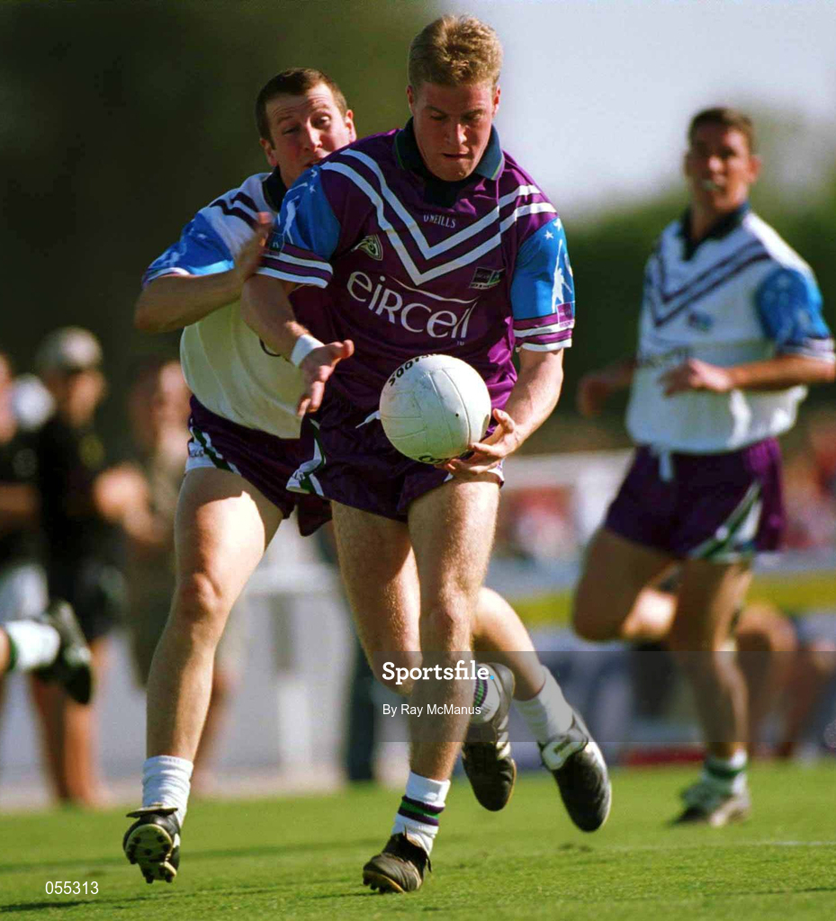 26 January 2001; Anthony Lynch of 1999 All Stars, races past Gary Fahey of 2000 All Stars during an exhibition match on the Eircell GAA All-Star tour at the Dubai Rugby Ground in Dubai, United Arab Emirates. Photo by Ray McManus/Sportsfile