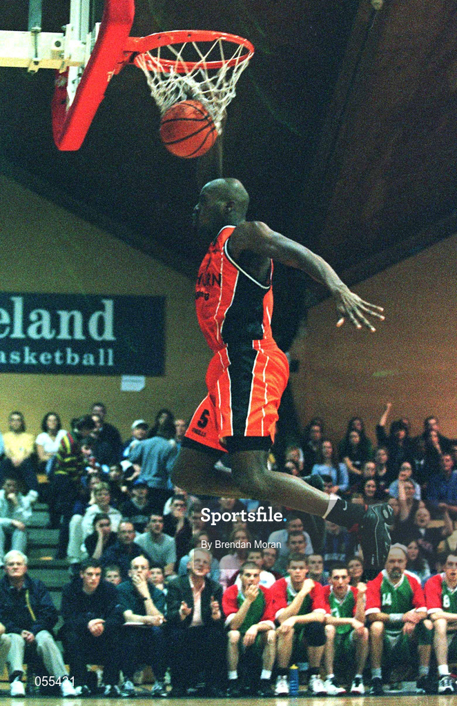 28 January 2001; Killester's Eric Jackson dunks the ball watched by the Longnecks Ballina bench during the ESB Men's Cup Final match between Killester and Longnecks Ballina at the National Basketball Arena in Tallaght, Dublin. Photo by Brendan Moran/Sportsfile