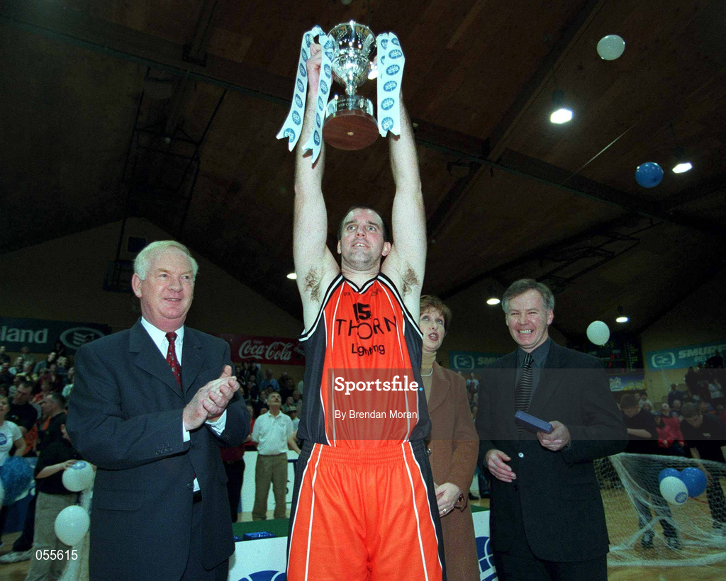 28 January 2001; Killester's John Leahy celebrates with the ESB cup, in the company of President Mary McAleese, Finn Ahern, President of IBA, and Ted Dalton of ESB following the ESB Men's Cup Final match between Killester and Longnecks Ballina at the National Basketball Arena in Tallaght, Dublin. Photo by Brendan Moran/Sportsfile