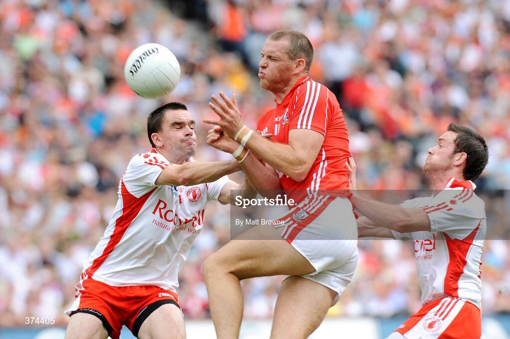 23 August 2009; Pearse O'Neill, Cork, is tackled by Ryan McMenamin and Martin Penrose, Tyrone. GAA Football All-Ireland Senior Championship Semi-Final, Tyrone v Cork, Croke Park, Dublin. Picture credit: Matt Browne / SPORTSFILE