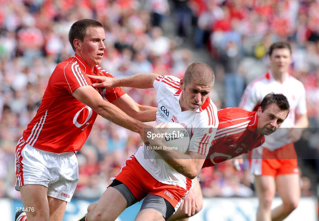 23 August 2009; Kevin Hughes, Tyrone, is tackled by Patrick Kelly and Paul Kerrigan, Cork. GAA Football All-Ireland Senior Championship Semi-Final, Tyrone v Cork, Croke Park, Dublin. Picture credit: Matt Browne / SPORTSFILE