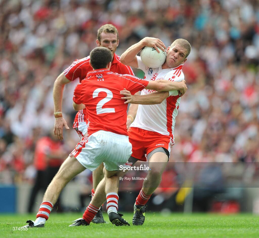 23 August 2009; Kevin Hughes, Tyrone, is tackled by Nicholas Murphy and Ray Carey, Cork. GAA Football All-Ireland Senior Championship Semi-Final, Tyrone v Cork, Croke Park, Dublin. Picture credit: Ray McManus / SPORTSFILE