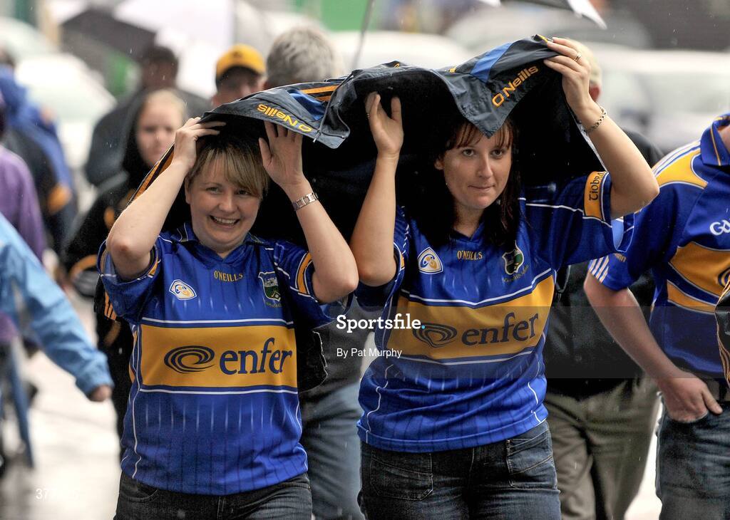 6 September 2009; Tipperary supporters shelter from the rain on their way to Croke Park. GAA Hurling All-Ireland Senior Championship Final, Kilkenny v Tipperary, Croke Park, Dublin. Picture credit: Pat Murphy / SPORTSFILE