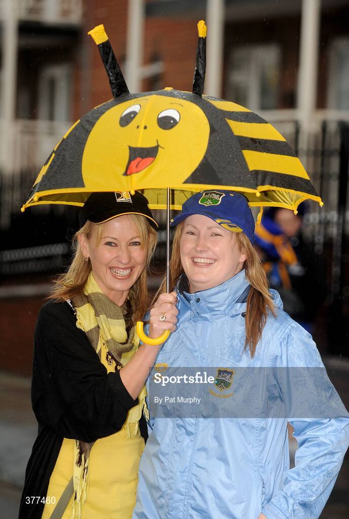 6 September 2009; Martina Cronin, supporting Kilkenny, and Lyndsay McHugh, supporting Tipperary, shelter from the rain before the game. GAA Hurling All-Ireland Senior Championship Final, Kilkenny v Tipperary, Croke Park, Dublin. Picture credit: Pat Murphy / SPORTSFILE