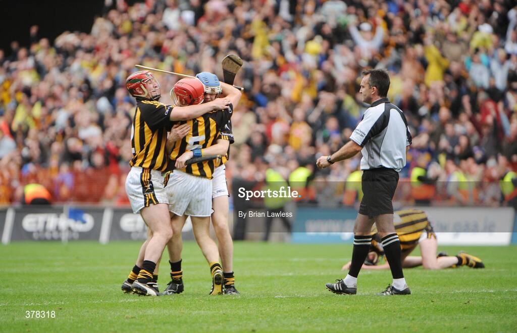 6 September 2009; Referee, Diarmuid Kirwan, tries to retrieve the sliothar from, Tommy Walsh, as he celebrates with team-mates Eoin Larkin, left, and T.J. Reid after the game. GAA Hurling All-Ireland Senior Championship Final, Kilkenny v Tipperary, Croke Park, Dublin. Picture credit: Brian Lawless / SPORTSFILE