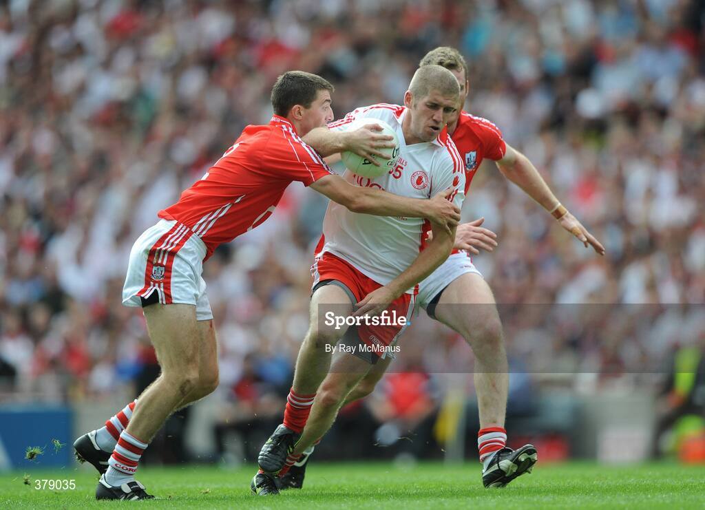 23 August 2009; Kevin Hughes, Tyrone, is tackled by Nicholas Murphy and Ray Carey, Cork. GAA Football All-Ireland Senior Championship Semi-Final, Tyrone v Cork, Croke Park, Dublin. Picture credit: Ray McManus / SPORTSFILE