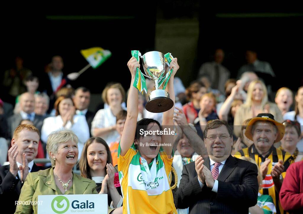 13 September 2009; Offaly captain Marion Crean lifts the New Ireland Cup in the company of An Taoiseach Brian Cowen TD and President of the Camogie Association Joan O'Flynn. Gala All-Ireland Junior Camogie Championship Final, Offaly v Waterford, Croke Park, Dublin. Picture credit: Brian Lawless / SPORTSFILE