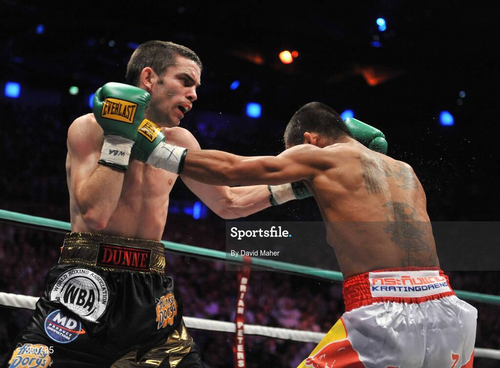 26 September 2009; Bernard Dunne exchanges punches with Poonsawat Kratingdaenggym, left, during the 1st round of their WBA World Super Bantamweight title fight. Hunky Dorys World Title Fight Night, Bernard Dunne v Poonsawat Kratingdaenggym, The O2, Dublin. Picture credit: David Maher / SPORTSFILE