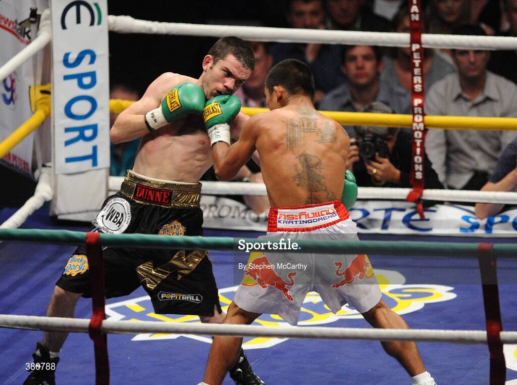 26 September 2009; Bernard Dunne exchanges punches with Poonsawat Kratingdaenggym, right, during the 2nd round of their WBA World Super Bantamweight title fight. Hunky Dorys World Title Fight Night, Bernard Dunne v Poonsawat Kratingdaenggym, The O2, Dublin. Picture credit: Stephen McCarthy / SPORTSFILE