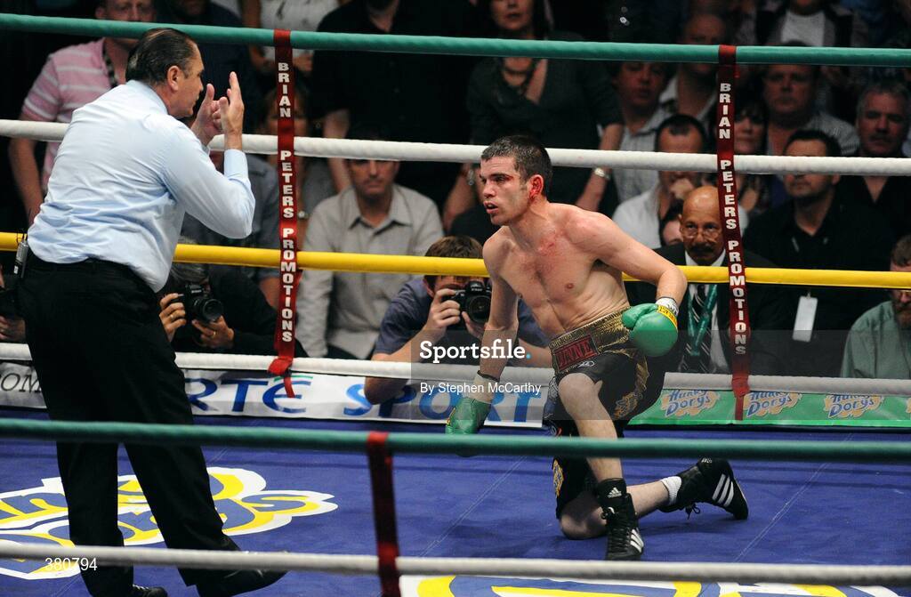 26 September 2009; A groggy Bernard Dunne is given a count by referee Jean Louis Legland during the third round of his WBA World Super Bantamweight title fight. Hunky Dorys World Title Fight Night, Bernard Dunne v Poonsawat Kratingdaenggym, The O2, Dublin. Picture credit: Stephen McCarthy / SPORTSFILE