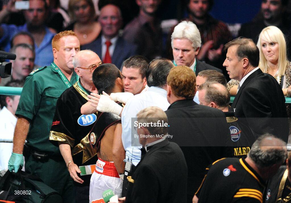 26 September 2009; A dejected Bernard Dunne is embraced by Poonsawat Kratingdaenggym after being defeated on the three knockdown rule after 2 minutes 57 seconds of the third round of their WBA World Super Bantamweight title fight. Hunky Dorys World Title Fight Night, Bernard Dunne v Poonsawat Kratingdaenggym, The O2, Dublin. Picture credit: Stephen McCarthy / SPORTSFILE