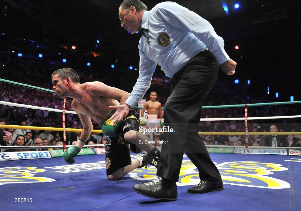 26 September 2009; Bernard Dunne is given a count from referee Jean Louis Legland during the third round of his WBA World Super Bantamweight title fight, with Poonsawat Kratingdaenggym. Hunky Dorys World Title Fight Night, Bernard Dunne v Poonsawat Kratingdaenggym, The O2, Dublin. Picture credit: David Maher / SPORTSFILE