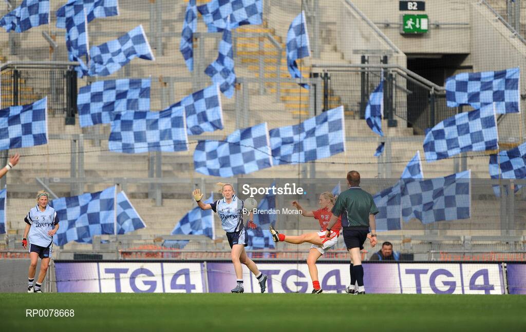 27 September 2009; Nollaig Cleary, Cork, kicks a point watched by Sorcha Furlong, Dublin. TG4 All-Ireland Ladies Football Senior Championship Final, Cork v Dublin, Croke Park, Dublin. Picture credit: Brendan Moran / SPORTSFILE