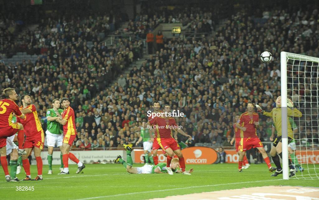 14 October 2009; Vukasin Poleksic, Montenegro, right, watches as Richard Dunne's header comes off the crossbar. 2010 FIFA World Cup Qualifier, Republic of Ireland v Montenegro, Croke Park, Dublin. Picture credit: Oliver McVeigh / SPORTSFILE