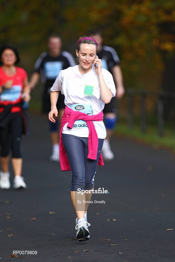 26 October 2009; A competitor takes a phone call during the Lifestyle Sports - adidas Dublin Marathon 2009. Phoenix Park, Dublin. Picture credit: Tomas Greally / SPORTSFILE