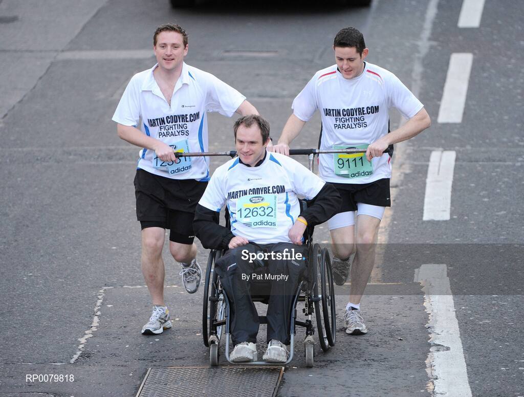 26 October 2009; Conor Galvin, 9111, Brian Codyre, left, and Martin Codyre, Dublin, in action during the Lifestyle Sports - adidas Dublin Marathon 2009. Martin is being assisted in completing the marathon after being paralysed for life after a tragic accident. Merrion Square, Dublin. Picture credit: Pat Murphy / SPORTSFILE