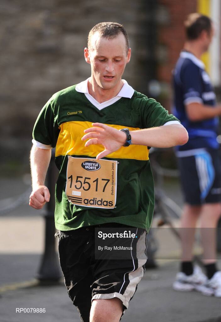 26 October 2009; Gerard O'Sullivan, from Greater London, and wearing a Kerry jersey, checks his time after the 16 mile mark during the Lifestyle Sports - adidas Dublin Marathon 2009. Dublin. Picture credit: Ray McManus / SPORTSFILE