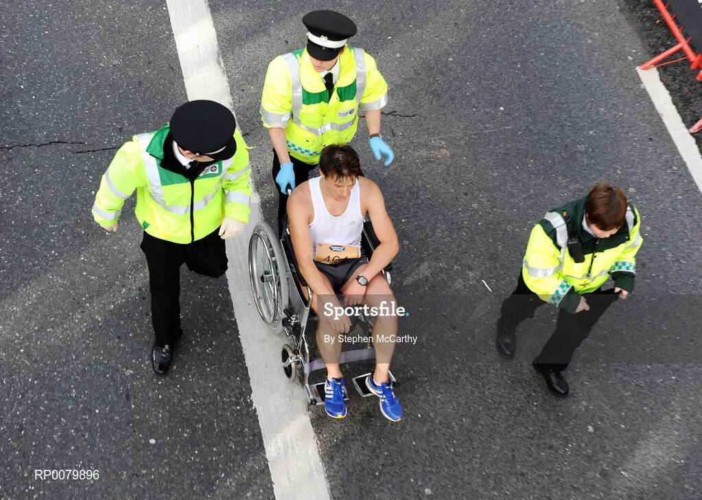 26 October 2009; A competitor is assisted by members of the St. John's Ambulance after the Lifestyle Sports - adidas Dublin Marathon 2009. Merrion Square, Dublin. Picture credit: Stephen McCarthy / SPORTSFILE
