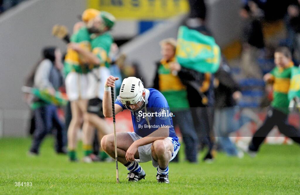 1 November 2009; A dejected Michael Gleeson, Thurles Sarsfields, at the final whistle as Newtownshandrum players and supposters celebrate. AIB GAA Hurling Munster Senior Club Championship Quarter-Final, Thurles Sarsfields v Newtownshandrum, Semple Stadium, Thurles, Co. Tipperary. Picture credit: Brendan Moran / SPORTSFILE