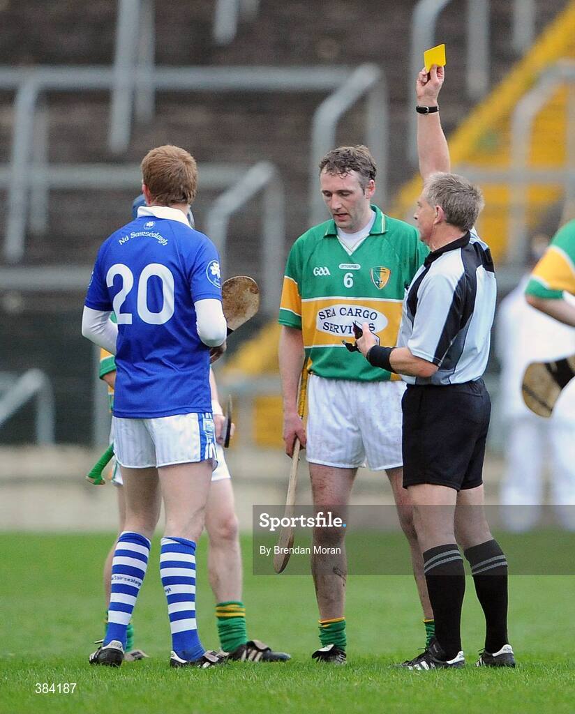 1 November 2009; Pat Mulcahy, Newtownshandrum, and Ger 'Redser' O'Grady, Thurles Sarsfields, are both shown a yellow card by referee Ger Hoey. AIB GAA Hurling Munster Senior Club Championship Quarter-Final, Thurles Sarsfields v Newtownshandrum, Semple Stadium, Thurles, Co. Tipperary. Picture credit: Brendan Moran / SPORTSFILE