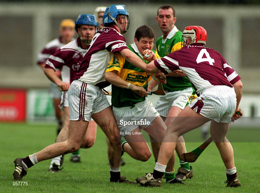 25 February 2001; Liam Redmond of Dunloy is tackled by Brian Hanley, 9, and John Feeney, 4, of Athenry during the AIB All-Ireland Senior Club Hurling Championship Semi-Final match between Athenry and Dunloy at Parnell Park in Dublin. Photo by Ray Lohan/Sportsfile