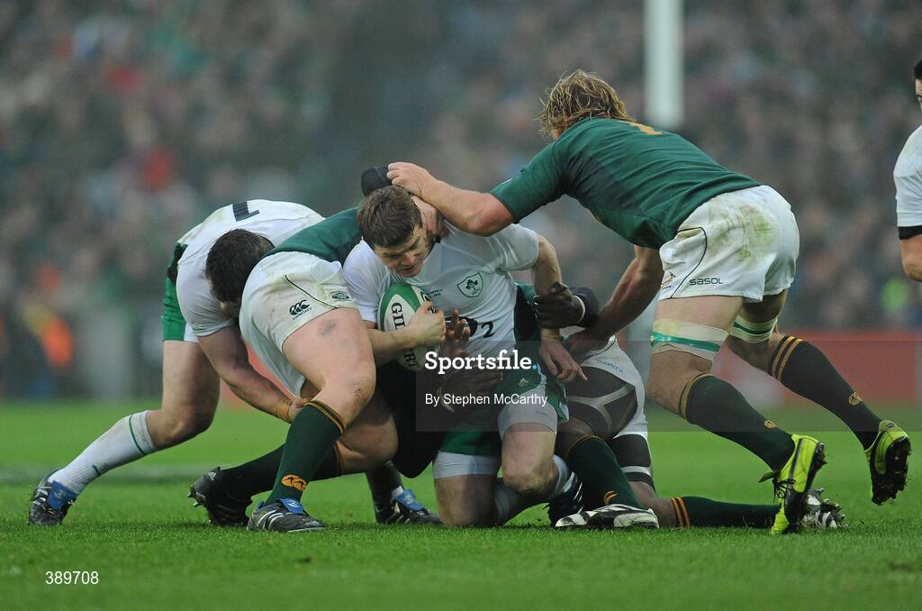 28 November 2009; Brian O'Driscoll, Ireland, is tackled by South Africa players, from left, John Smit, Tendai Mtawarira and Schalk Burger. Autumn International Guinness Series 2009, Ireland v South Africa, Croke Park, Dublin. Picture credit: Stephen McCarthy / SPORTSFILE