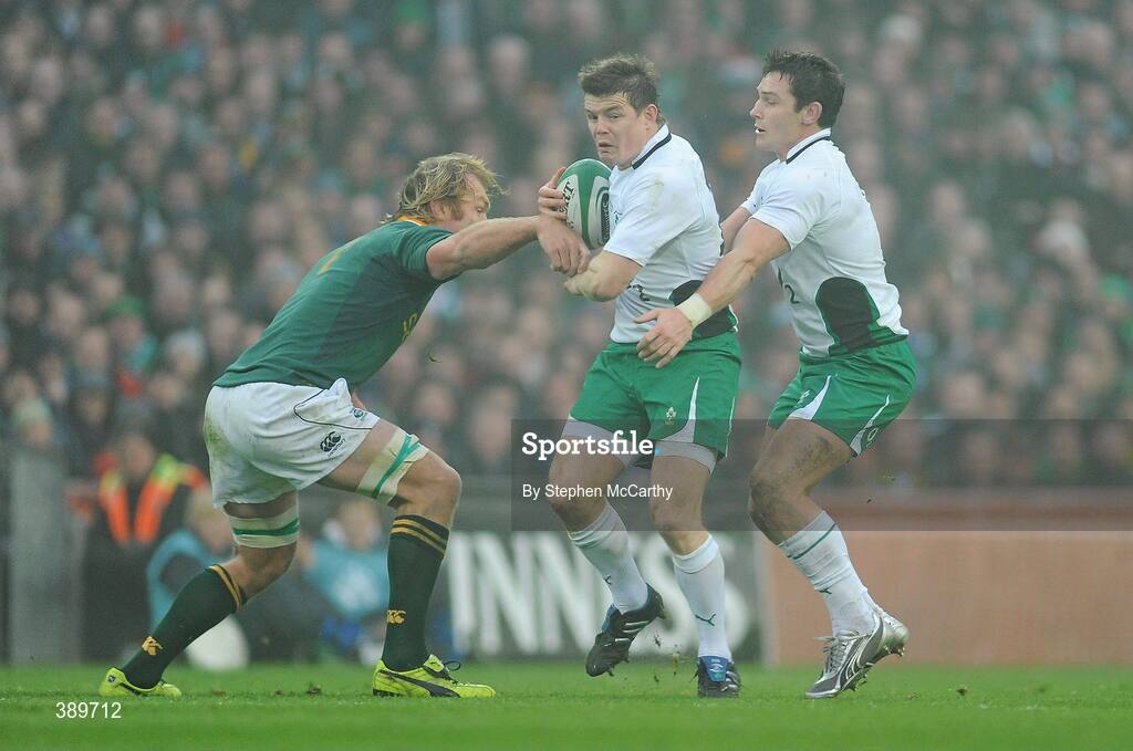 28 November 2009; Brian O'Driscoll, Ireland, supported by team-mate David Wallace, is tackled by Schalk Burger, South Africa. Autumn International Guinness Series 2009, Ireland v South Africa, Croke Park, Dublin. Picture credit: Stephen McCarthy / SPORTSFILE