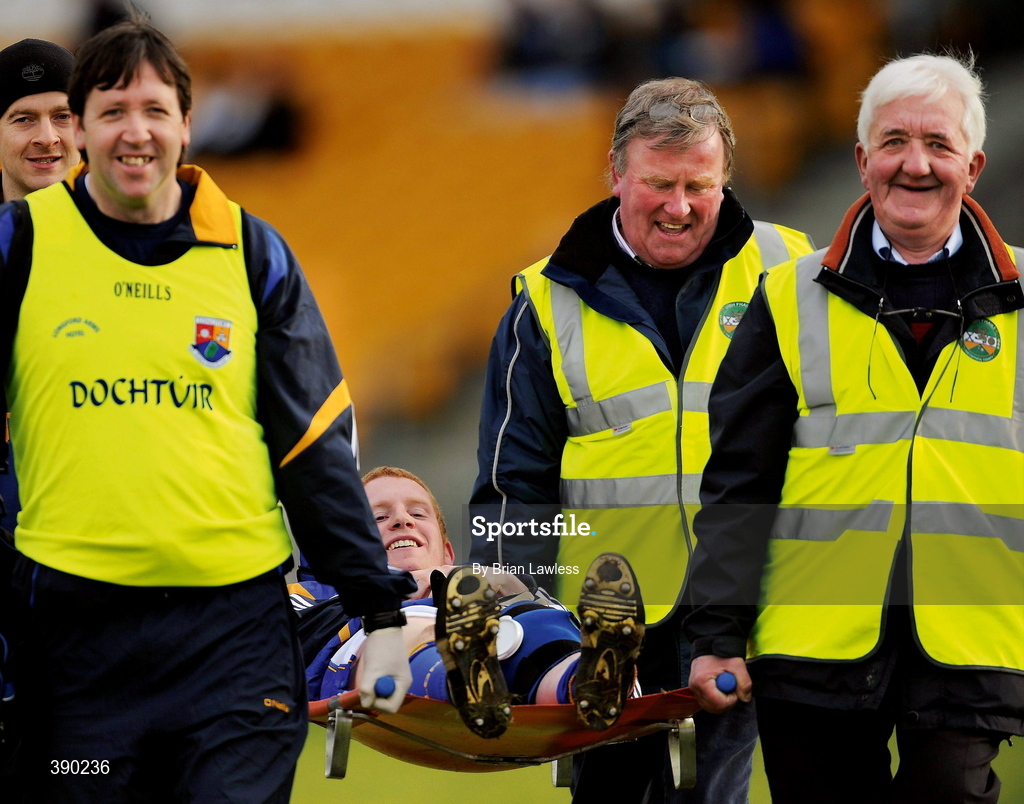 15 February 2009; Say, cheese! Longford’s Colm Flynn and his four stretcherbearers manage some smiles as the player is carried from the field in Tullamore. Picture credit: Brian Lawless / SPORTSFILE      This image may be reproduced free of charge when used in conjunction with a review of the book "A Season of Sundays 2009". All other usage © SPORTSFILE