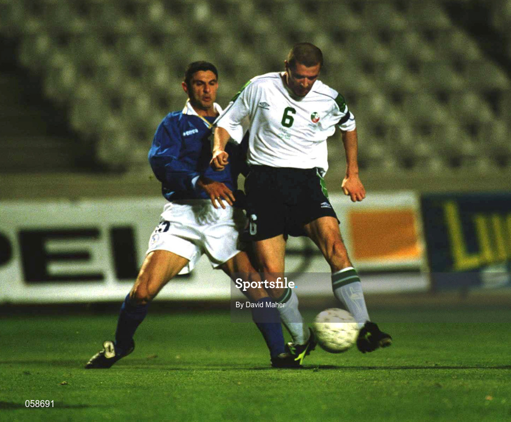 24 March 2000; Roy Keane of Republic of Ireland scores his side's fourth goal despite the tackle from Marios Christodoulou of Cyprus during the 2002 FIFA World Cup Qualification Group 2 match between Cyprus and Republic of Ireland at GSP Stadium in Nicosia, Cyprus. Photo by Damien Eagers/Sportsfile