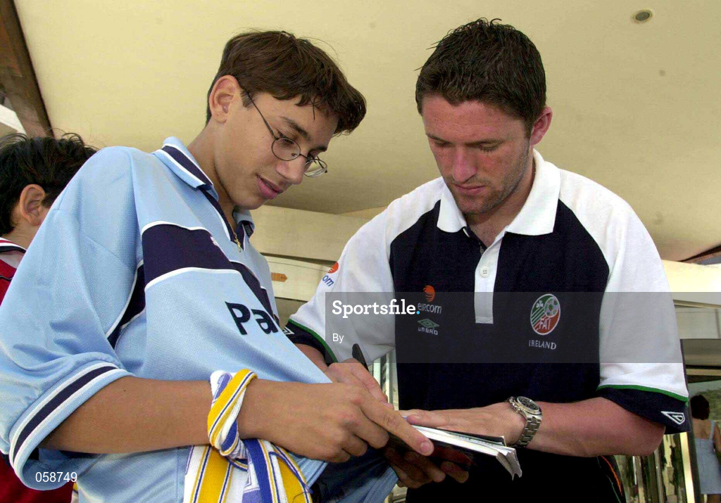 26 March 2001; Robbie Keane signs a autograph for a local Leeds United supporter outside the team hotel, Limassol, Cyprus, before the team depart for Barcelona. Soccer.  Picture credit; David Maher / SPORTSFILE *EDI*