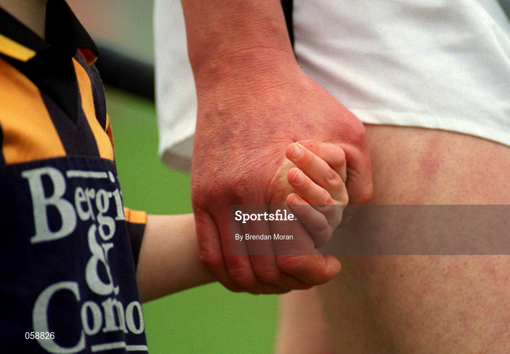 25 March 2001; A young Mascot holds the hand of the Seir Kieran team captain during the pre-match parade before the Offaly County Senior Hurling Championship Final match between Birr and Seir Kieran at St Brendan's Park in Birr, Offaly. Photo by Brendan Moran/Sportsfile