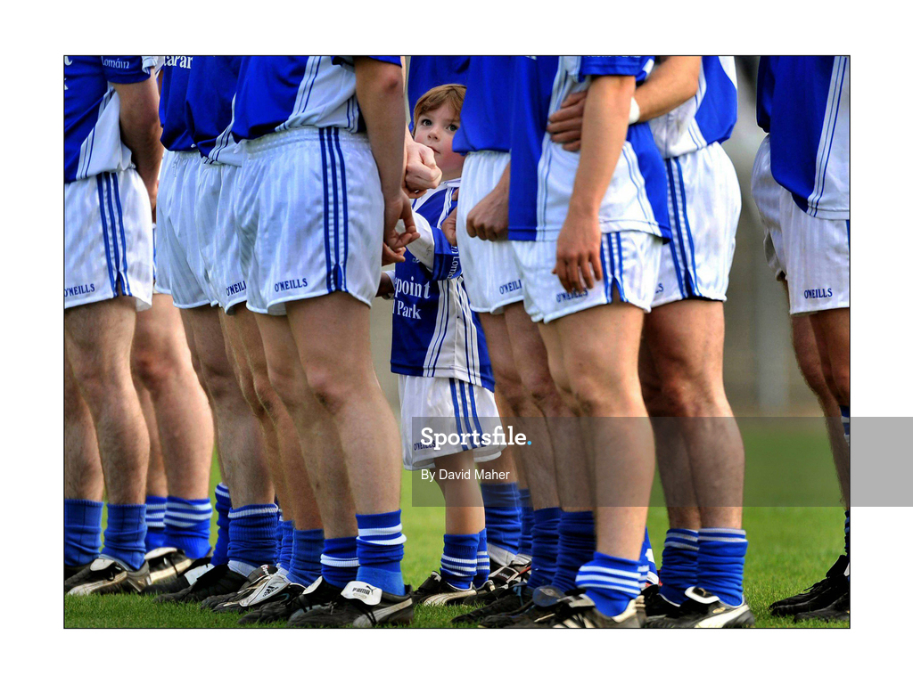 4 October 2009; Mascot Killian Plunkett stands with the players of St Loman's, Mullingar, during the playing of the national anthem. Westmeath County Senior Football Final, St Loman's, Mullingar v Garrycastle, Cusack Park, Mullingar, Co. Westmeath. Picture credit: David Maher / SPORTSFILE