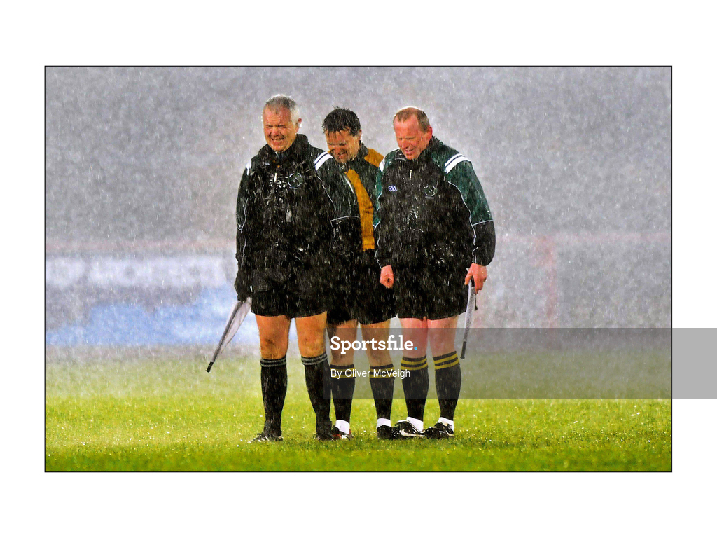 7 March 2009; Match officals, from left to right, Seamus McGonigle, linesman, Maurice Deegan, referee, and Barry Toland, linesman, withstand a torrential down pour during the National Anthem. Allianz GAA National Football League, Division 1, Round 3, Tyrone v Galway, Healy Park, Omagh, Co. Tyrone. Picture credit: Oliver McVeigh / SPORTSFILE