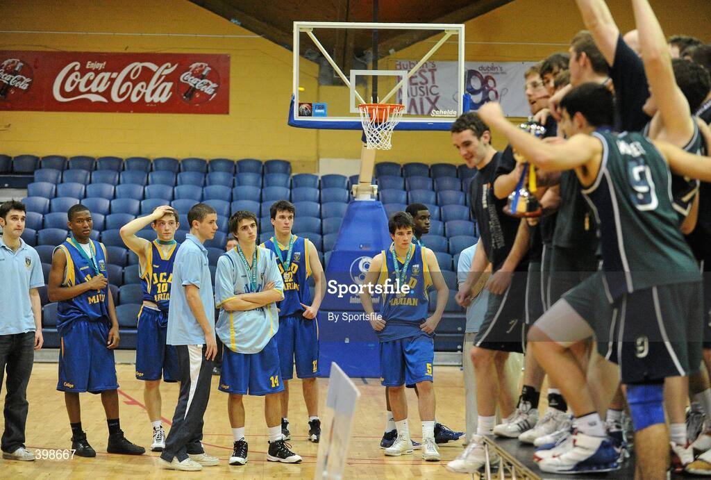 30 January 2010; Dejected UCD players look on as the trophy is being presented to Maree, Galway. Mens Under-20 National Cup Final, UCD Marian, Dublin v Maree, Galway, National Basketball Arena, Tallaght, Dublin. Photo by Sportsfile
