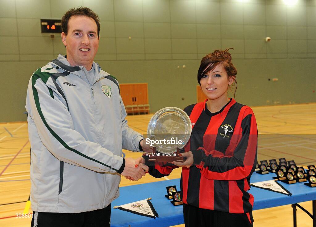 30 January 2010; Ger Dunne, FAI , presents the Plate trophy to Trinity captain Megan Capper. WSCAI National Futsal Plate Final, Trinity v NUIM, Kingfishers Sports Centre, NUIG, University Road, Galway. Picture credit: Matt Browne / SPORTSFILE